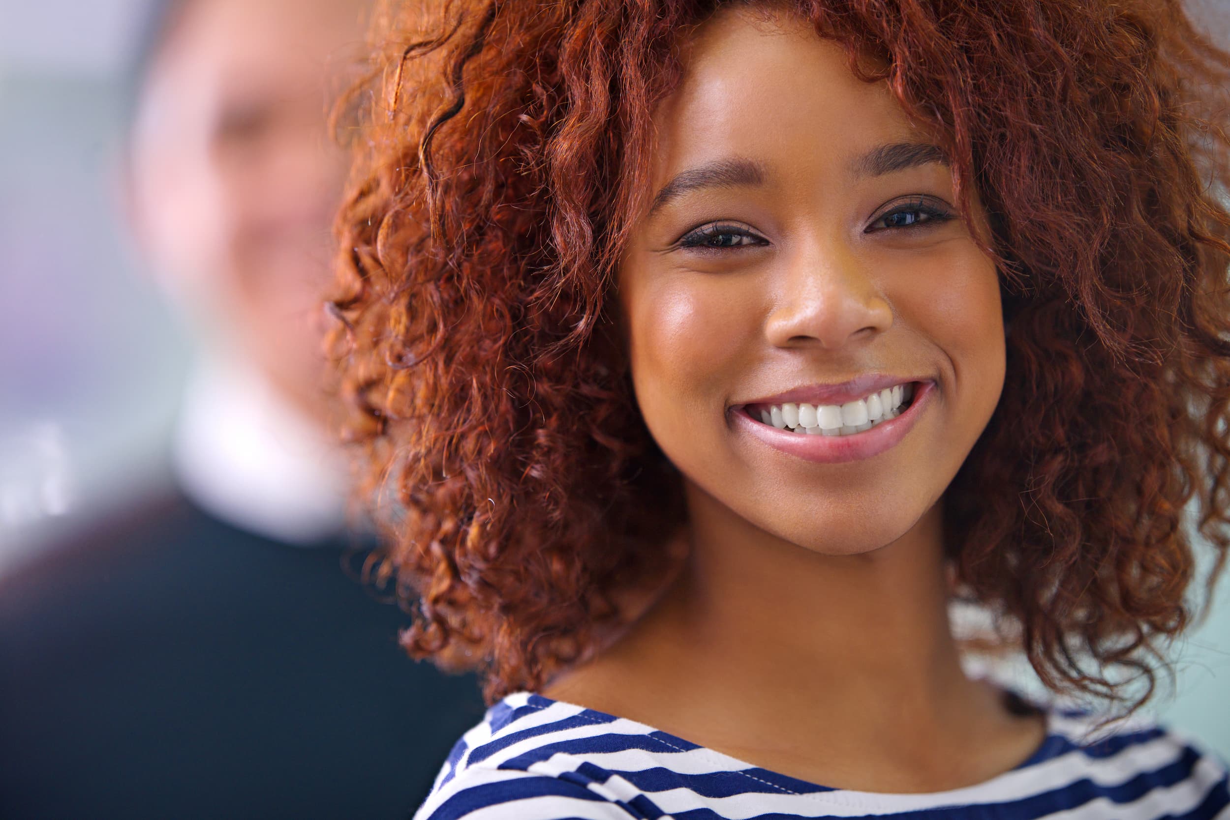 Smiling woman showing bright white teeth after cosmetic dental treatment