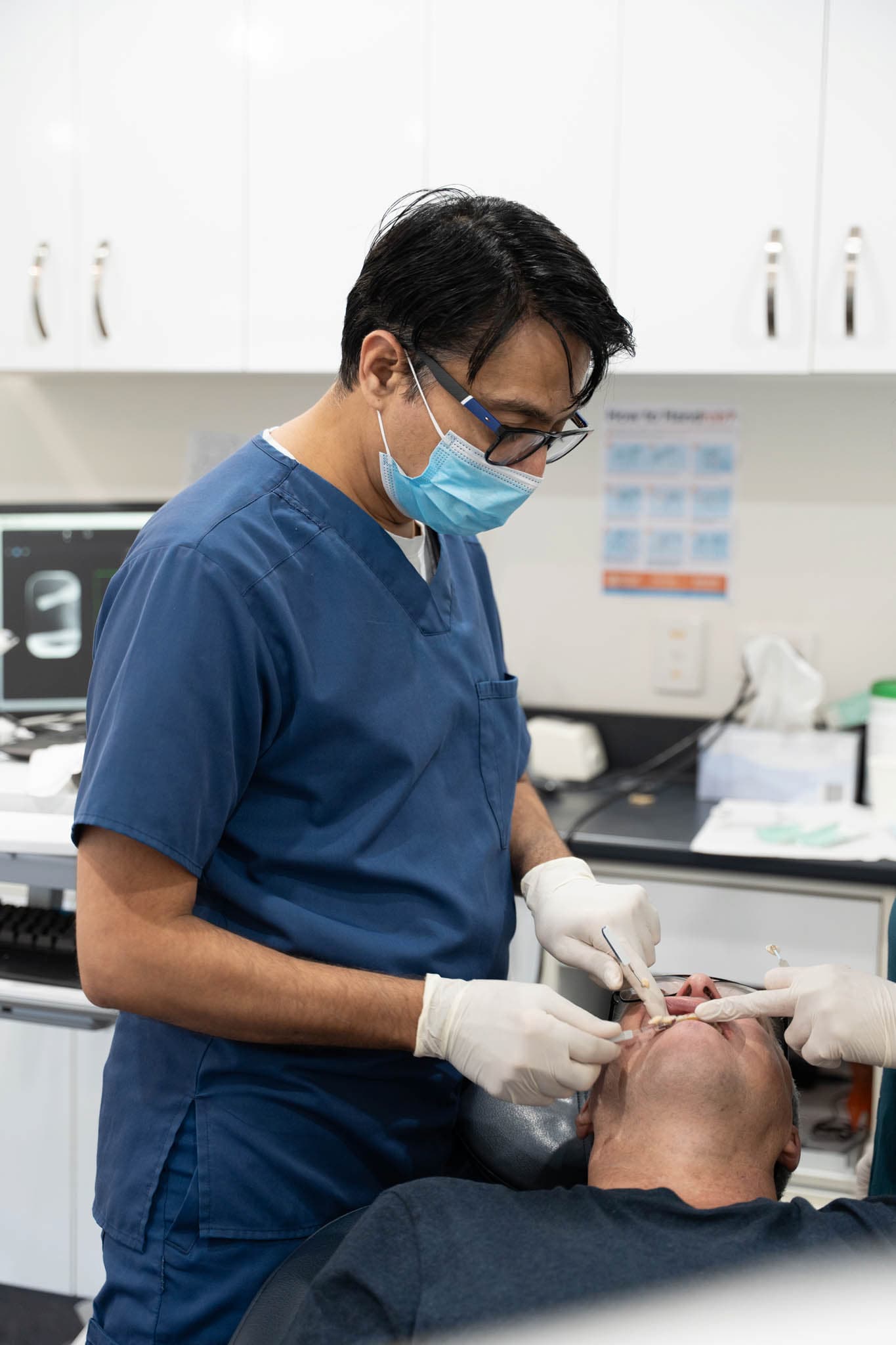 Dentist treating patient during urgent dental emergency
