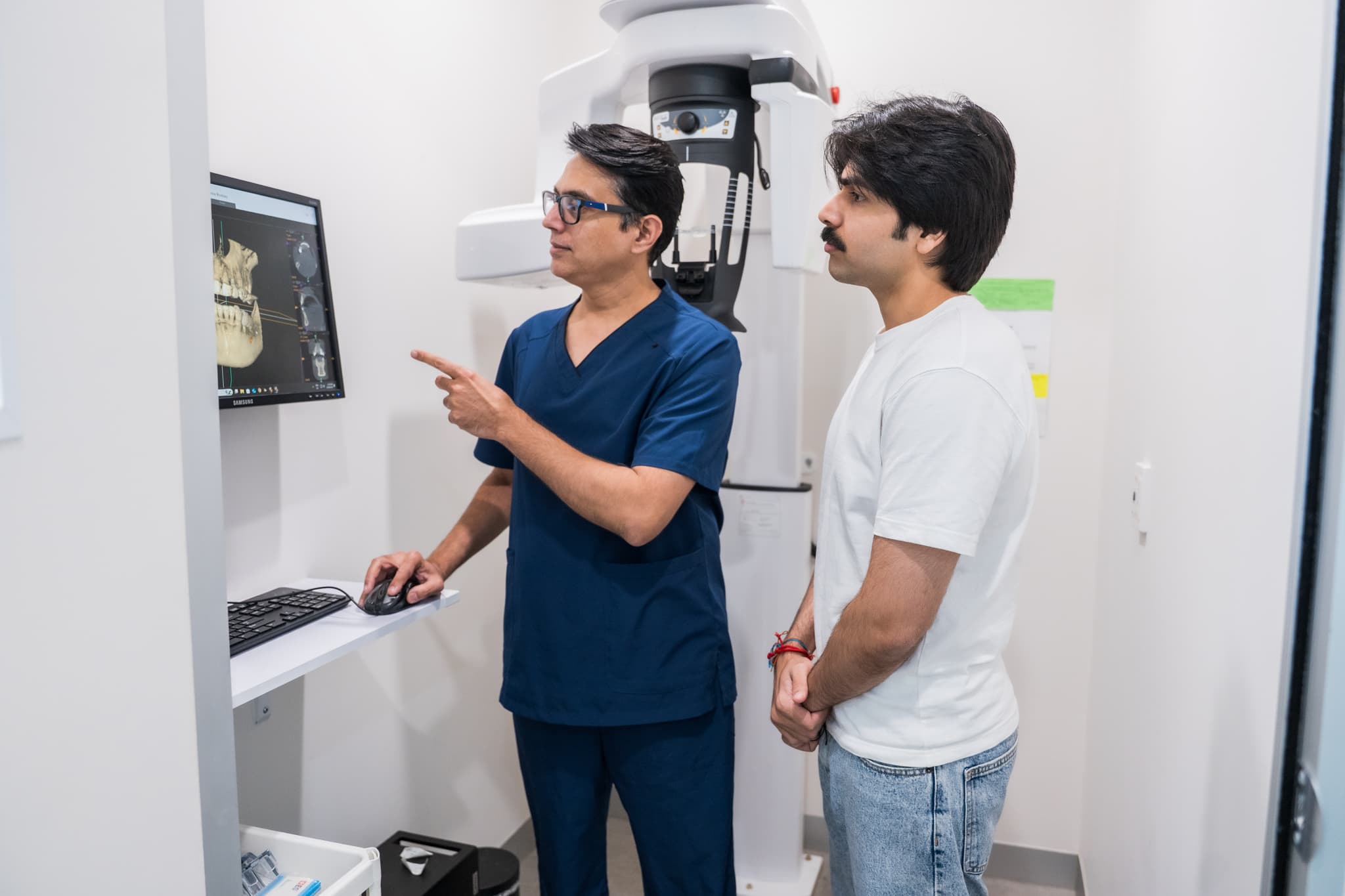 Dentist reviewing 3D dental scan with patient