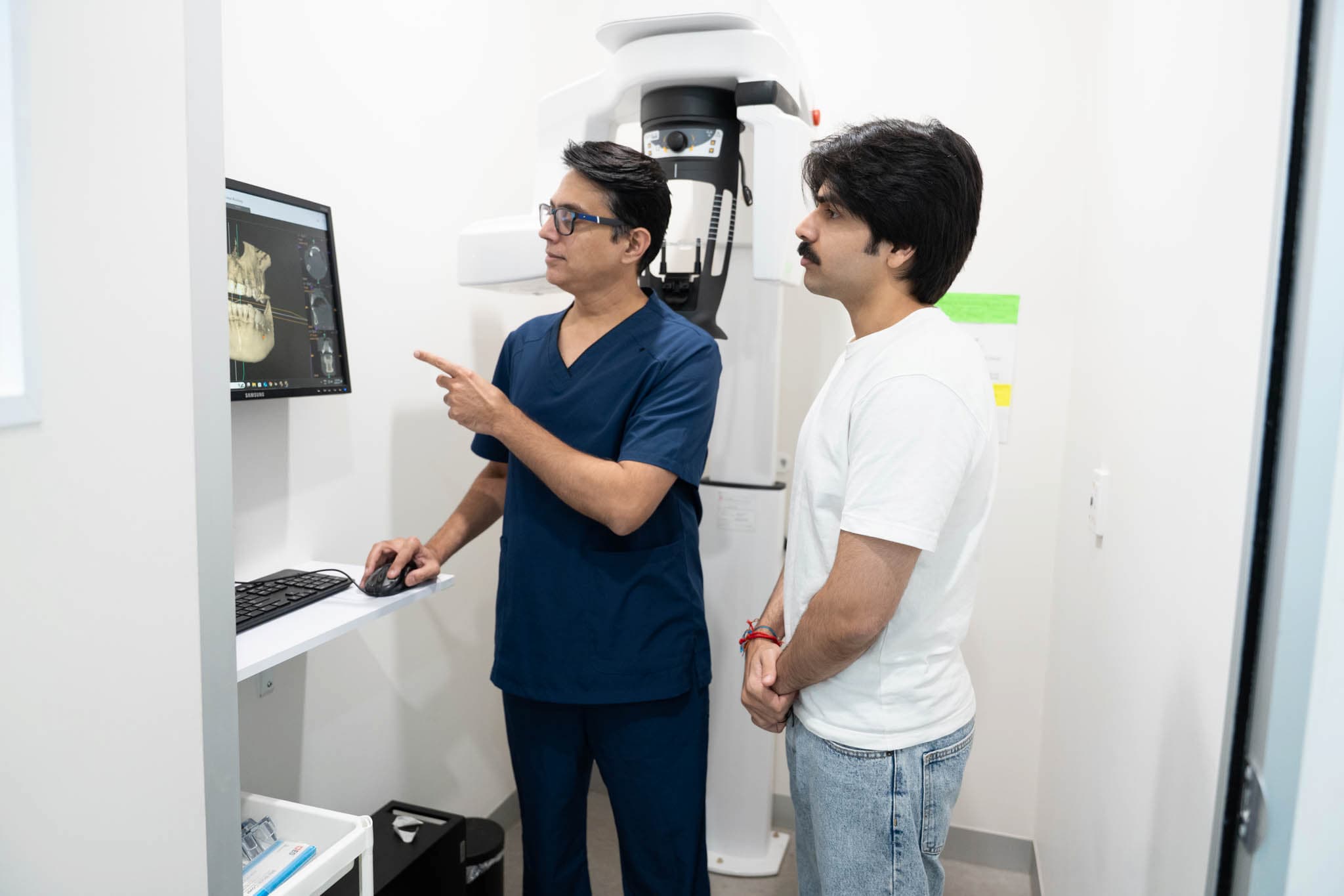 Dentist reviewing dental X-ray with patient during preventative care appointment