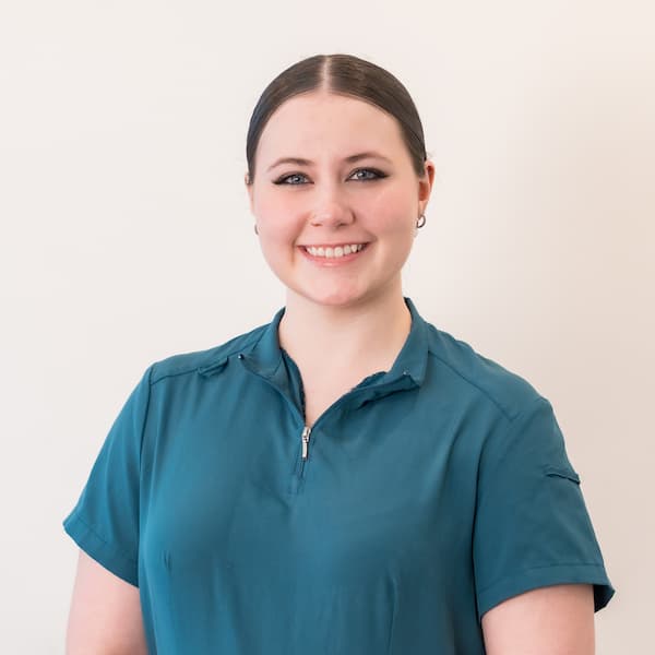 Kaydence, smiling receptionist at Exquisite Smiles.